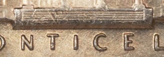 Side-by-side comparison of standard 1969-D nickel reverse steps versus Full Steps example showing clear separated lines
